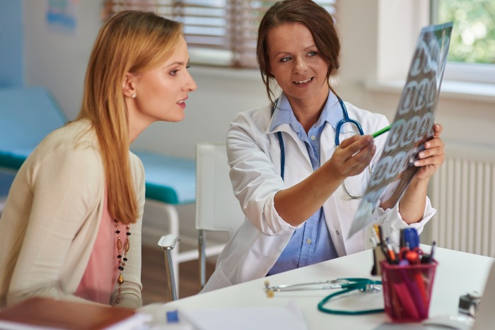 doctor showing scan to the patient